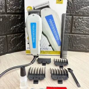Kit de máquina peluquera profesional con cable color gris, accesorios de corte, cepillo, aceite y peine sobre fondo de ladrillo.